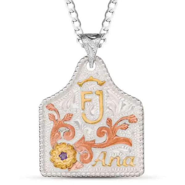 Add a touch of elegance with the Tanya Custom Cow Tag, crafted on a hand-engraved German Silver base. Detailed with a beaded edge, Copper scrolls, and a Jeweler's Bronze flower, this piece is a blend of sophistication and craftsmanship. Customize the lett